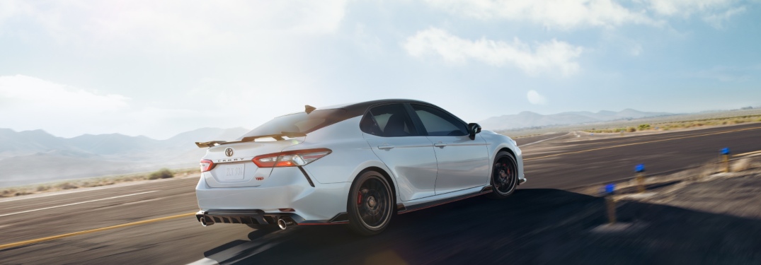 2020 Toyota Camry driving down a sunny highway road
