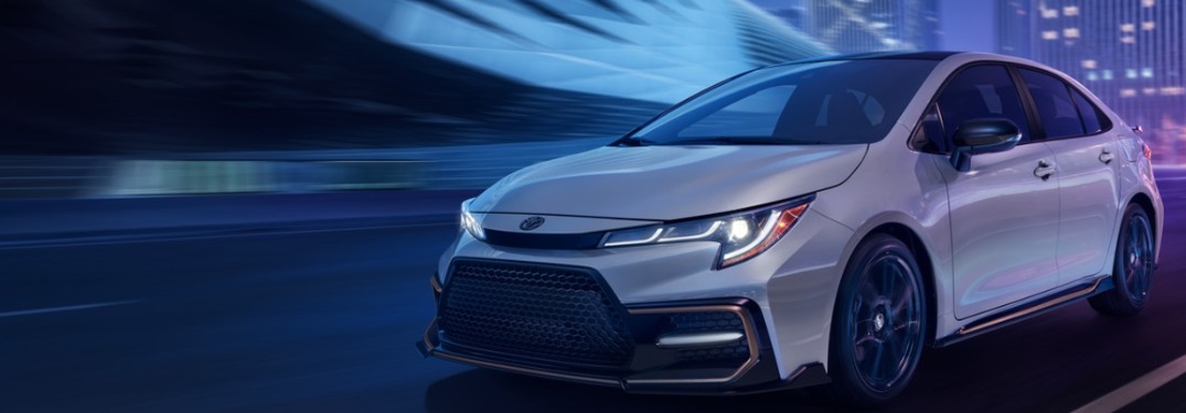 2021 Toyota Corolla Sedan driving down a highway road at night