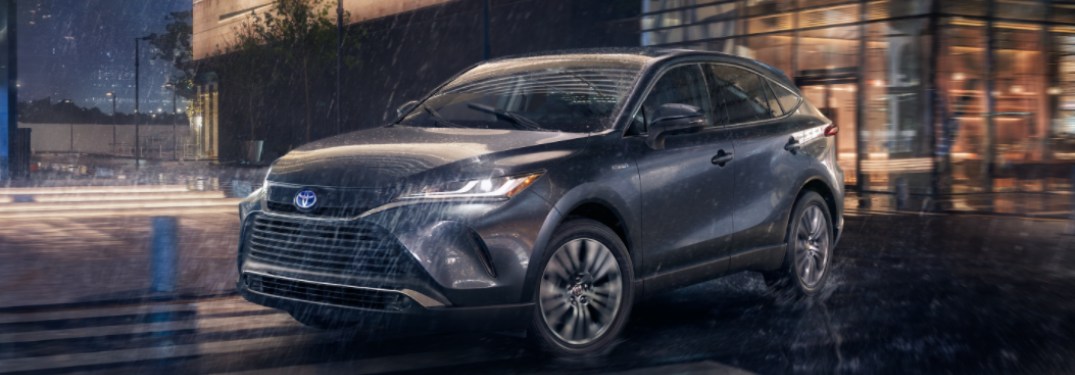 2021 Toyota Venza driving down a street in the rain