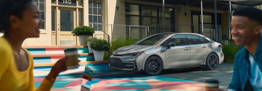 blurred to people in foreground 2021 Toyota Corolla exterior front fascia driver side in focus