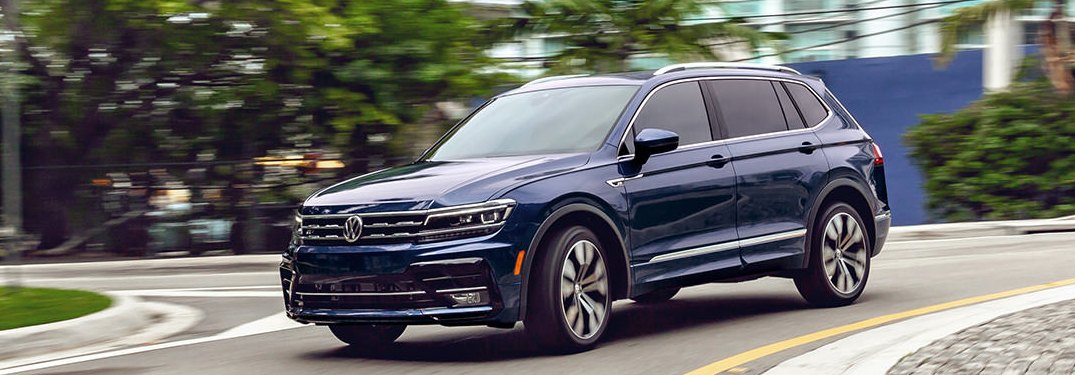 2021 Volkswagen Tiguan driving down a city street