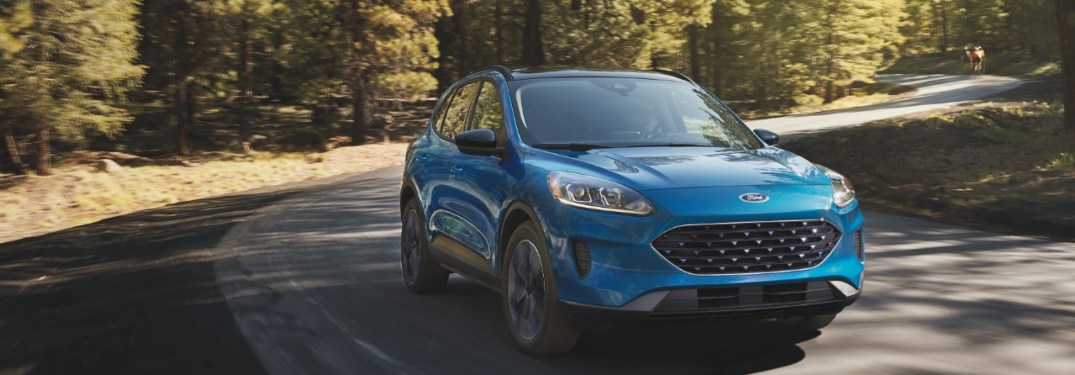 2021 Ford Escape driving down a road at sunset