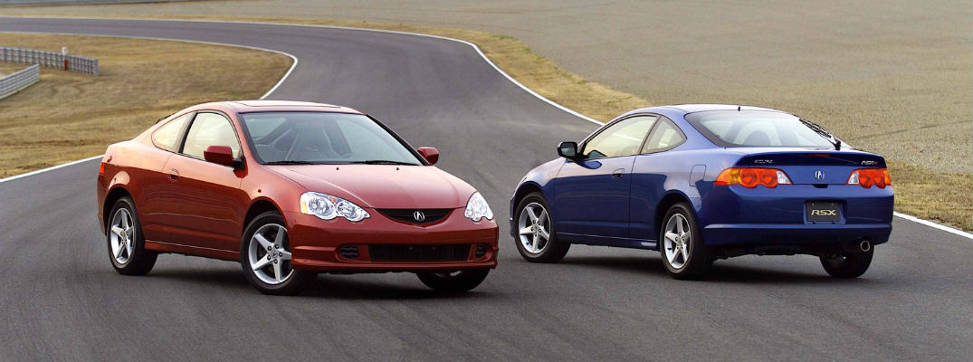 A photo of two Acura Type-S models parked side-by-side on a racetrack