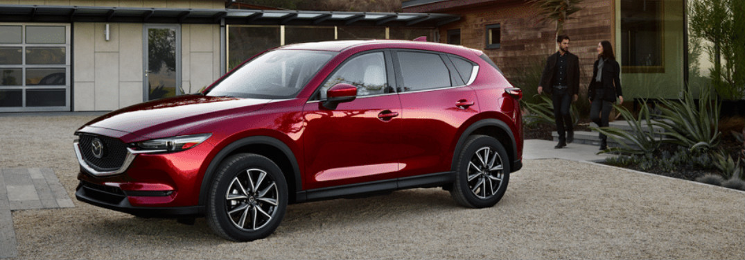 2018 Mazda CX-5 in red parked in a gravel driveway
