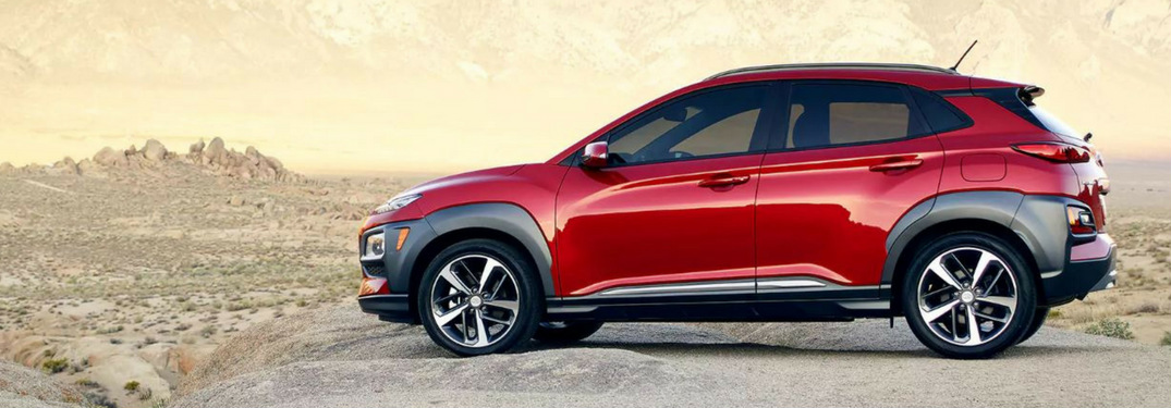 Side view of a red 2018 Hyundai Kona in the desert