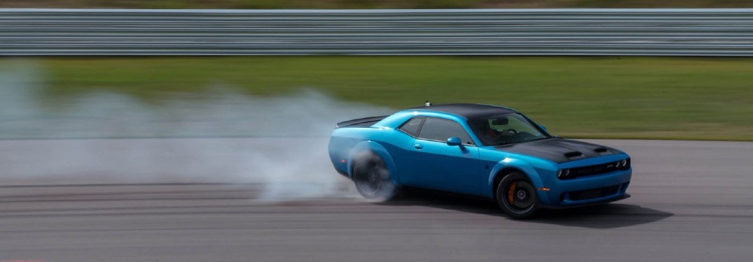 2020 Dodge Challenger blue smoke behind the tires motion blur