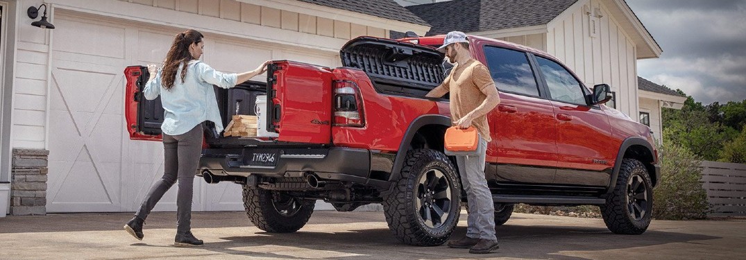 2020 Ram Multifunction Tailgate on Ram with red paint and couple getting supplies
