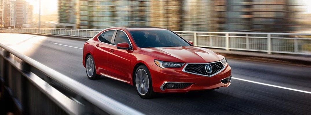 2020 Acura TLX SH-AWD advance package red color driving across city bridge featured image
