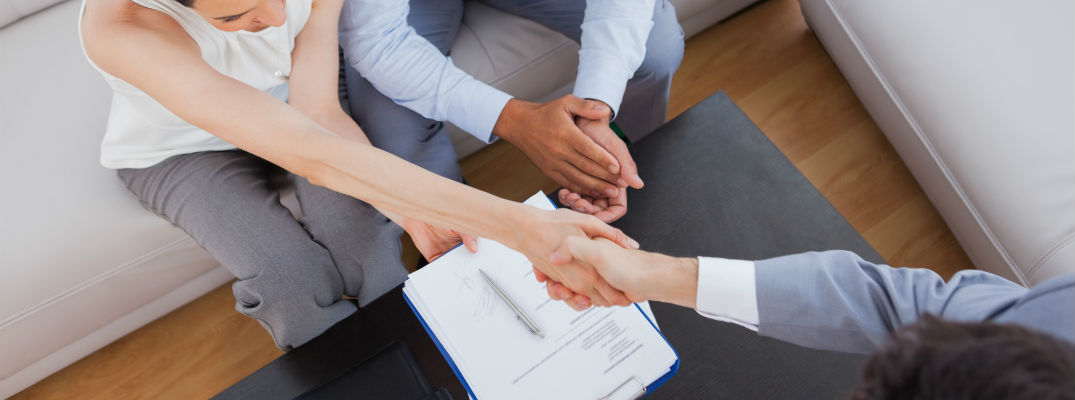 A stock photo of people shaking hands after completing a transaction.