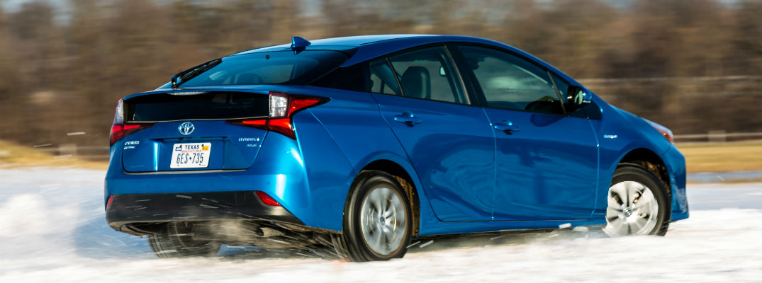 A photo of the new 2019 Toyota Prius driving through snow.