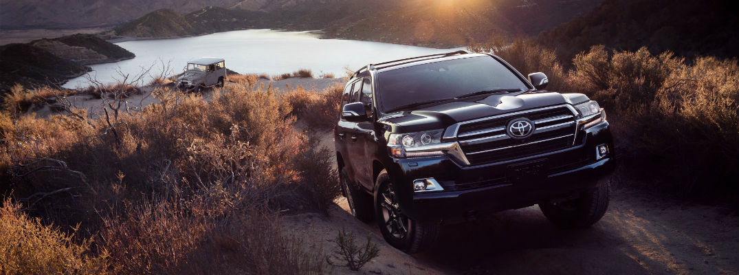 A photo of the 2020 Toyota Land Cruiser Heritage Edition climbing a hill with a first-generation model in the background.