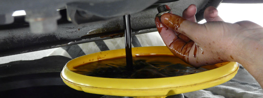 A stock photo of oil draining from an engine.
