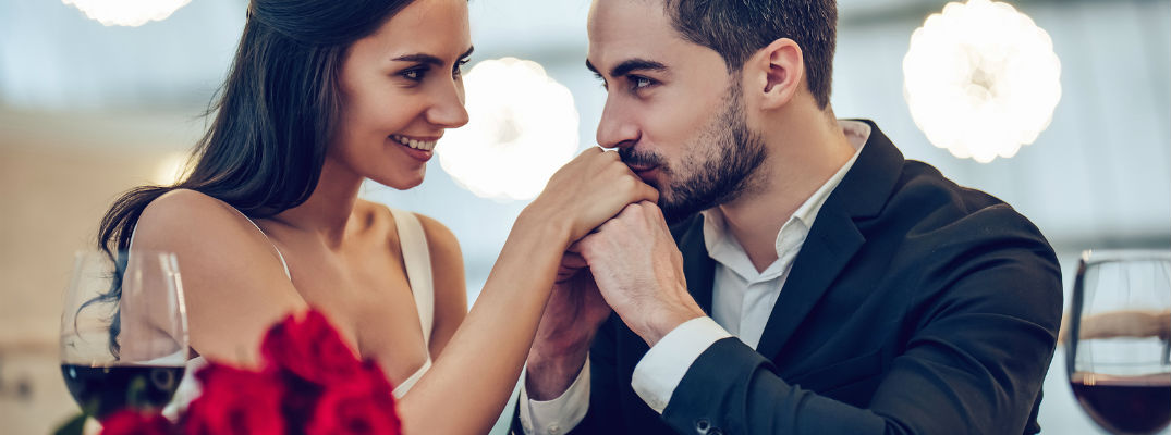 A stock photo of two people at a romantic dinner.
