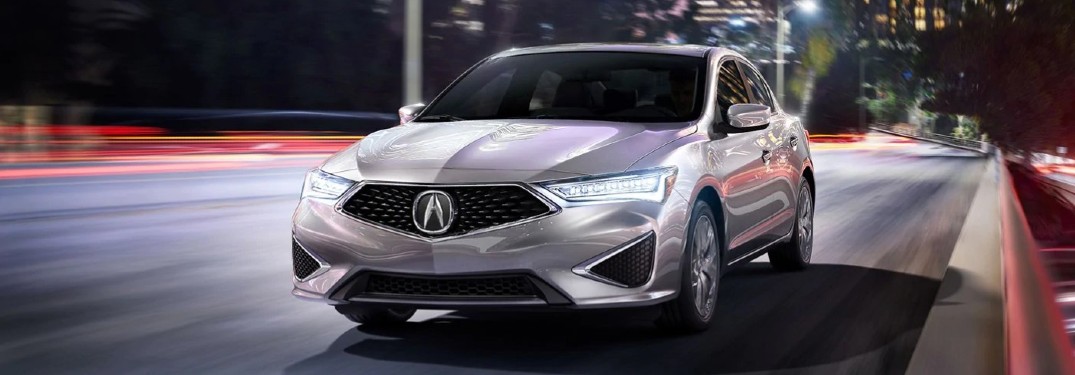 Front driver angle of a silver 2020 Acura ILX driving on a road