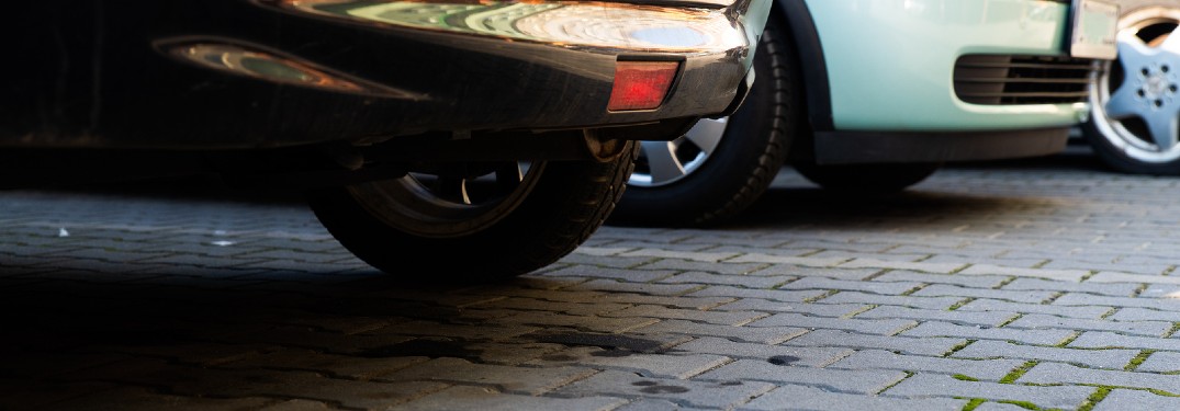 Oil spots on the ground underneath a car
