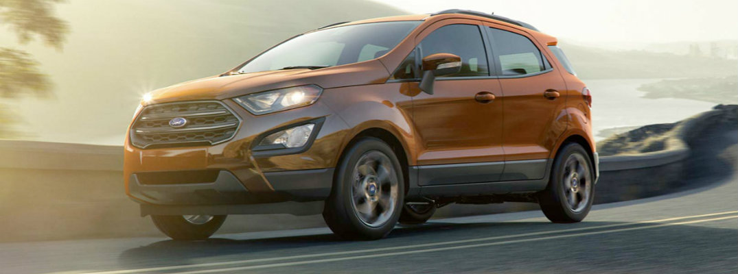 Burnt orange 2018 Ford EcoSport driving at dusk