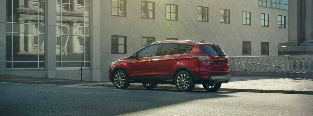 Red 2018 Ford Escape parked in front of modern building