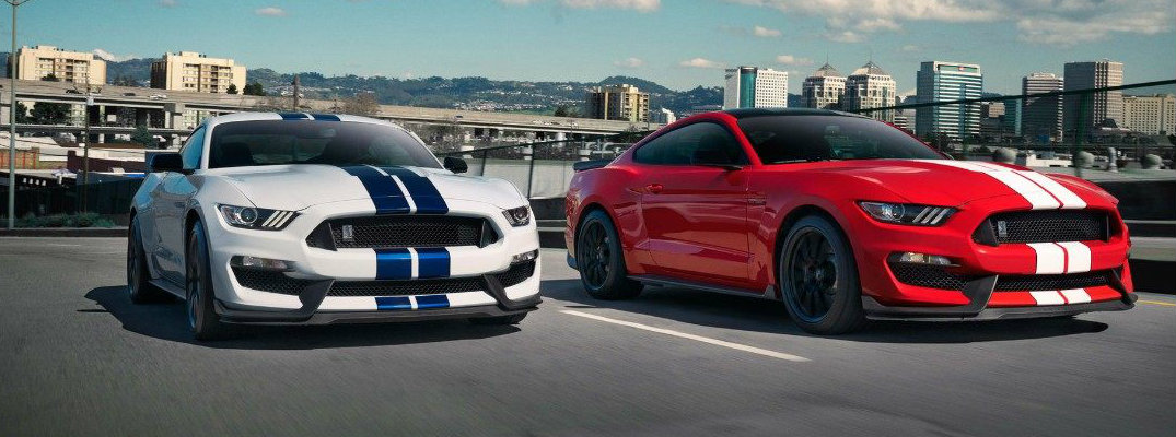 Two 2018 Ford Mustang Shelby GT350 models driving on highway in daytime