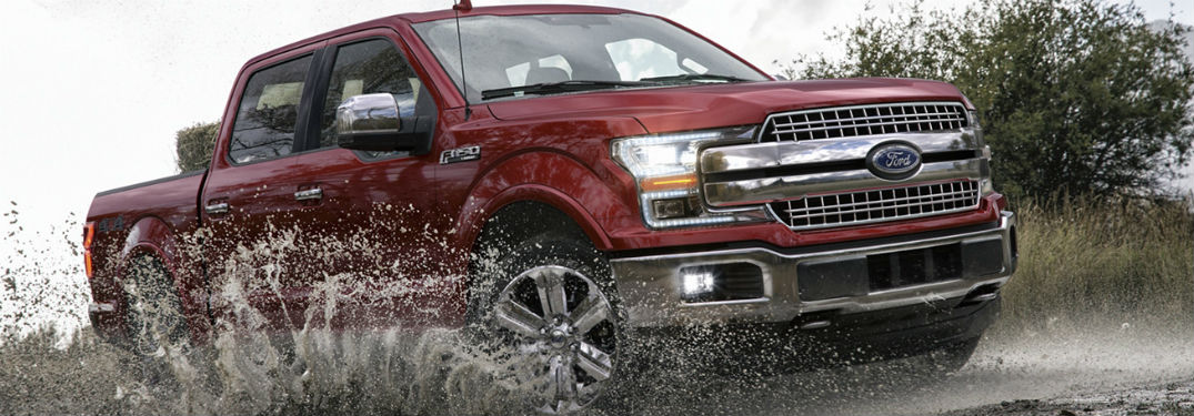 2020 Ford F-150 exterior front fascia passenger side driving through dirty puddle