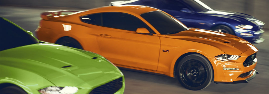 2020 Ford Mustang green orange and blue models racing passenger sides showing