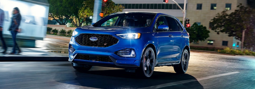 2020 Ford Edge exterior front fascia driver side on road with blurred people walking on sidewalk