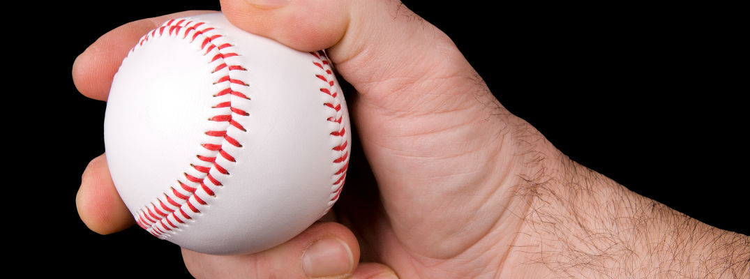 A stock photo of a pitcher's hand holding a baseball.