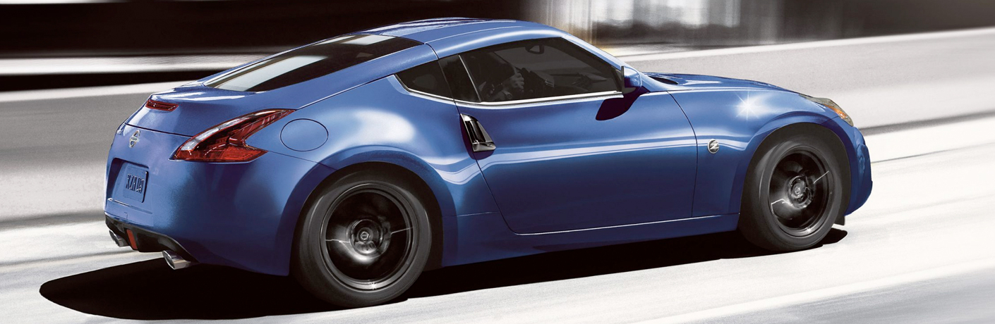Exterior view of a blue 2019 Nissan 370Z driving down the highway