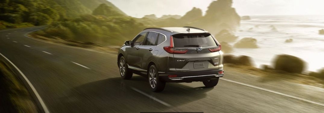 2021 Honda CR-V Hybrid Touring driving on a road by the sea