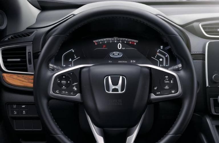 The steering wheel and dashboard of 2022 Honda CR-V Touring