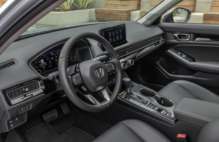 Steering wheel and interior of the 2022 Honda Civic Sedan Touring.