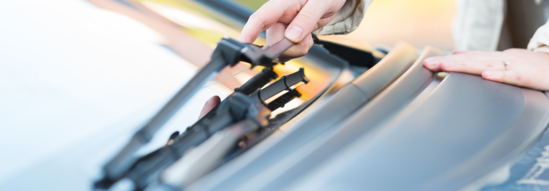 Woman touching windshield wipers