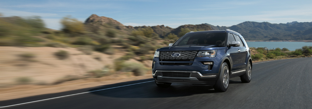 front view of blue 2018 ford explorer on desert road
