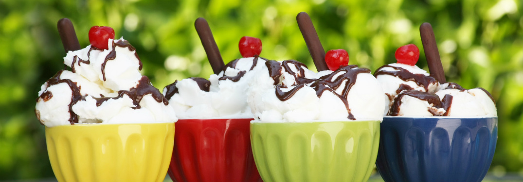 lineup of ice cream sundaes in colorful bowls