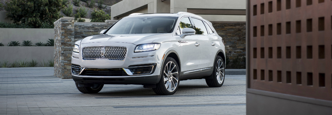 front and side view of white 2019 lincoln nautilus with new grille