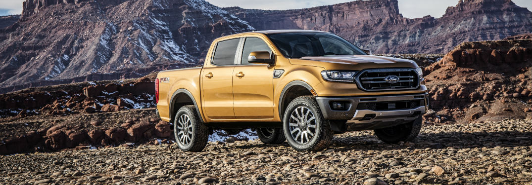 front and size view of bronze 2019 ford ranger with mountains behind it