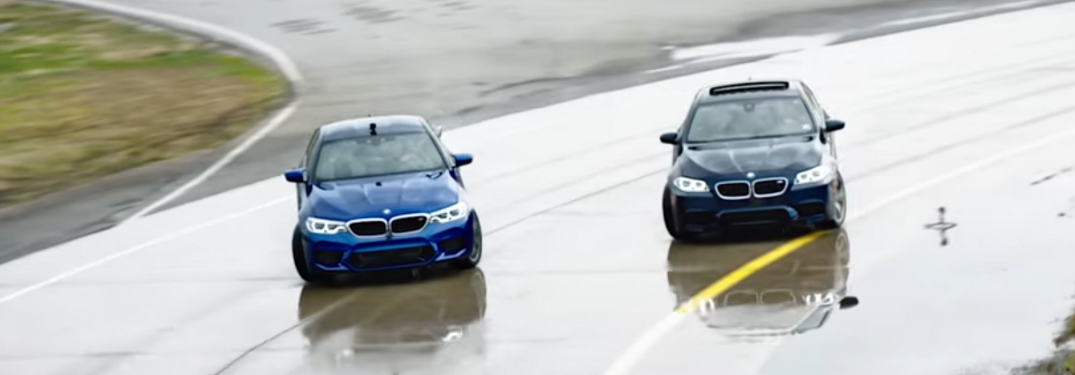 Two BMW M5 Vehicles Drifting on a Wet Race Track