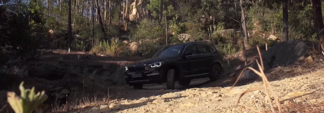 Black BMW SUV Driving on a Rocky Terrain