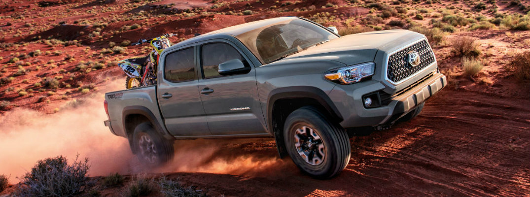 Gray 2018 Toyota Tacoma driving on rough terrain