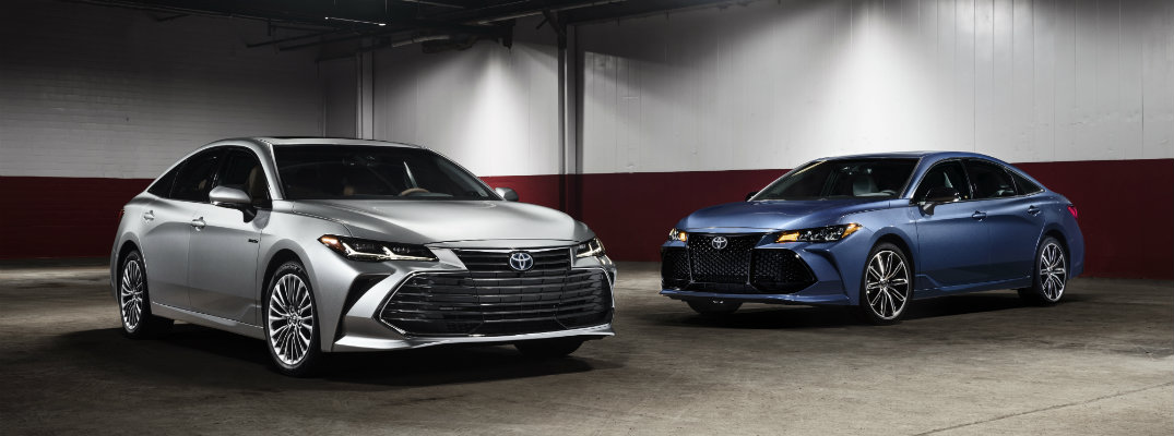 Silver and blue-colored 2019 Toyota Avalon models in a garage