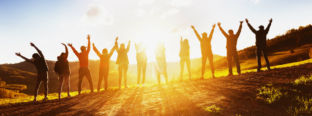 Line of people raising their hands and celebrating the environment