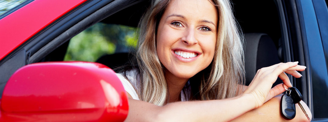 Young blonde woman with a set of Toyota keys