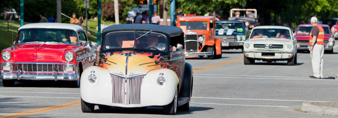 classic American cars driving down the road