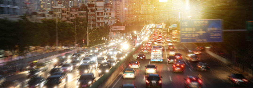 cars driving on a city highway in the evening