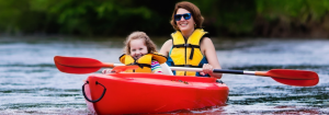 Mother and daughter paddling in kayak