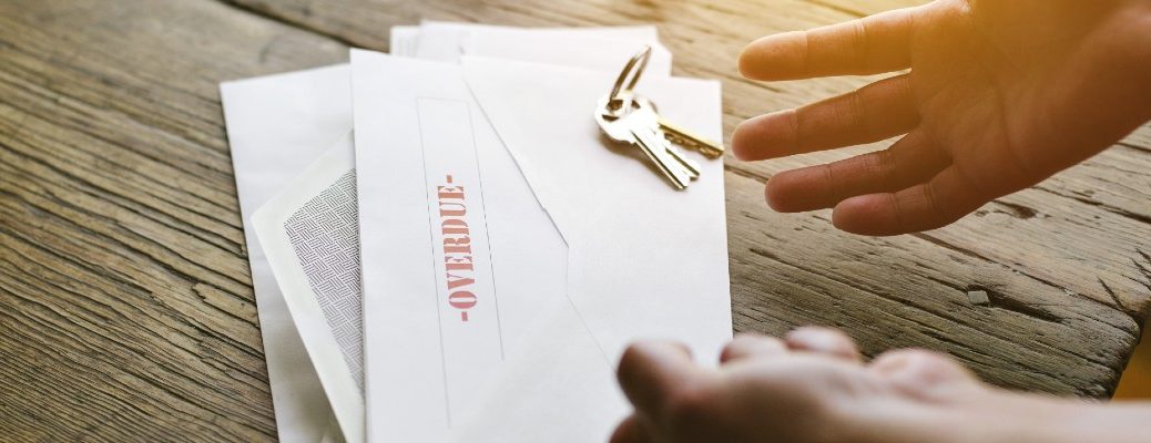 A stock photo of a person getting an overdue bill notice.