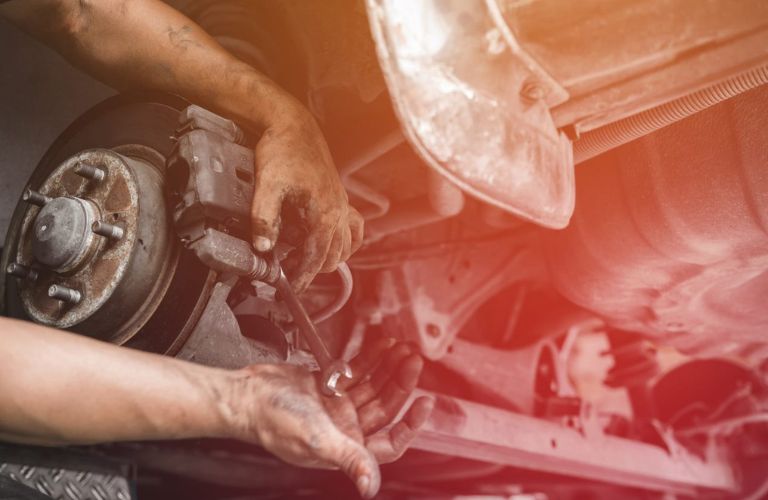 Close of image of a hand fixing the brake of a car.