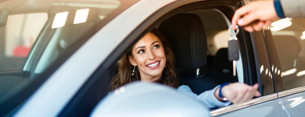 A woman inside a newly purchased car