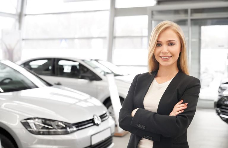 Sales person posing with the vehicle