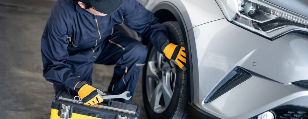 Mechanic checking vehicle tires