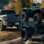 Rear view of the 2023 Nissan Frontier PRO-4X towing a quad-bike_o
